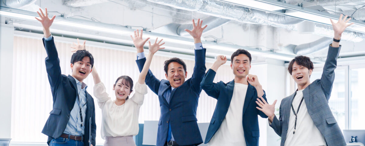 business people jumping for joy in the office.