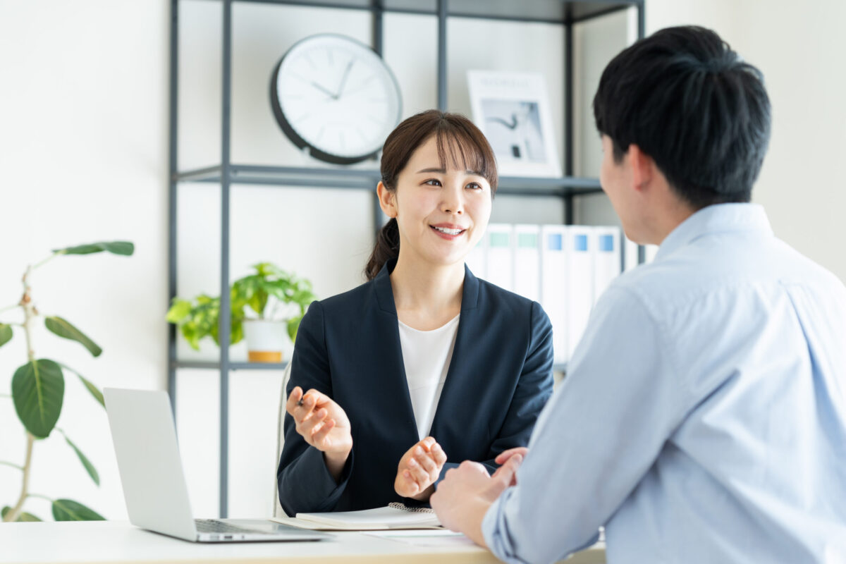 female consultant explaining to young man in office