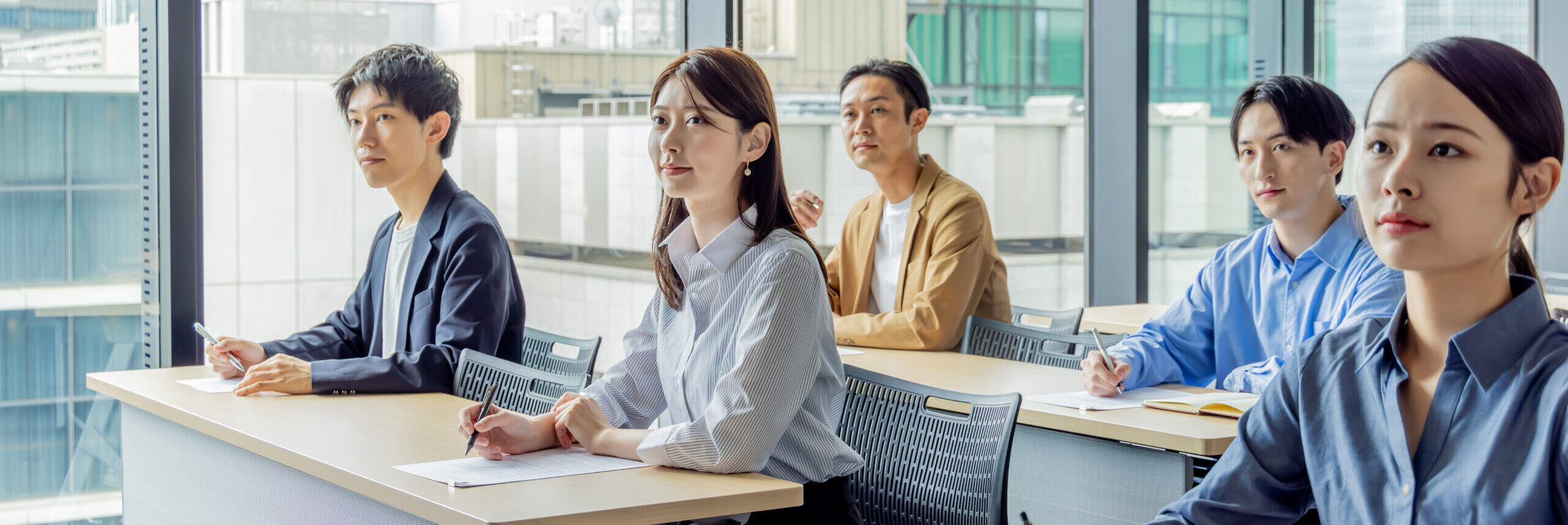 a group of asian men and women attending a seminar