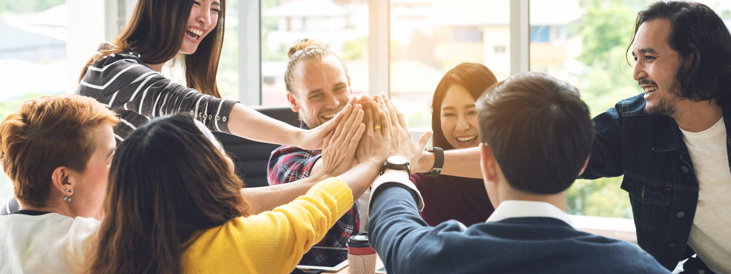gesture hand high five of group employee laughing together with achivement mission at millenial company. casual business with st